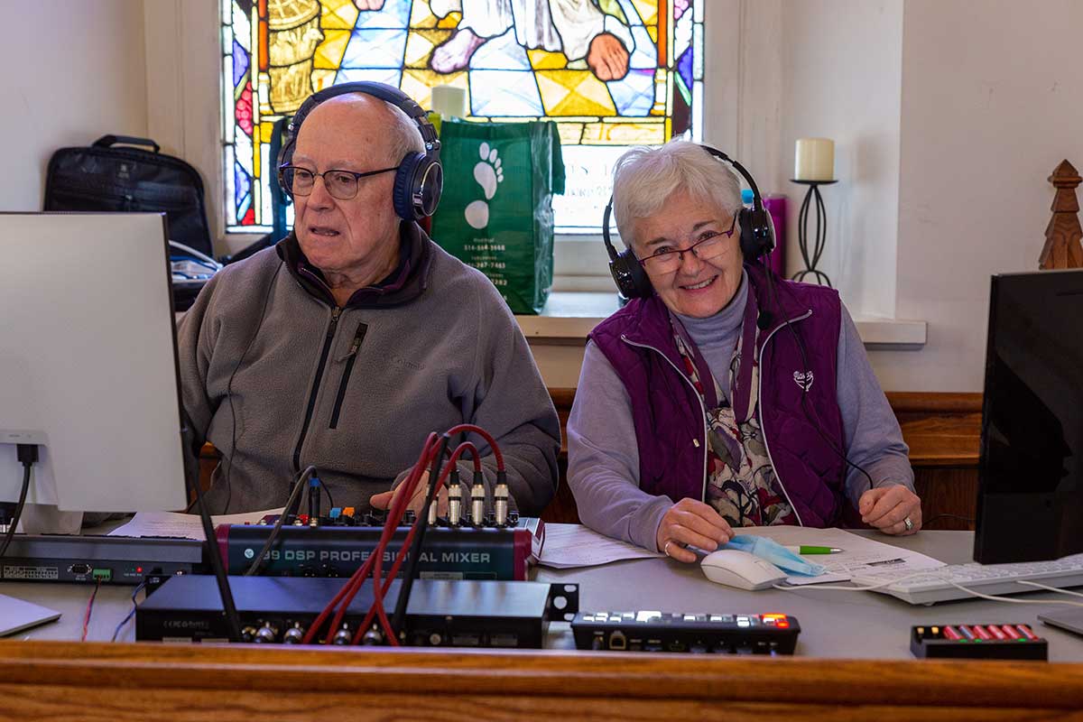 André and Wendy in front of audio equipment.